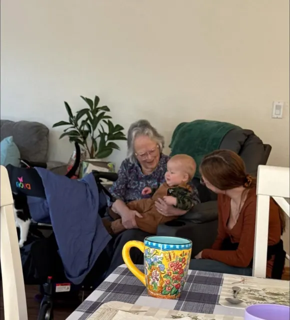Family and staff gathering with a resident at AAA Shepherd’s Care Home
