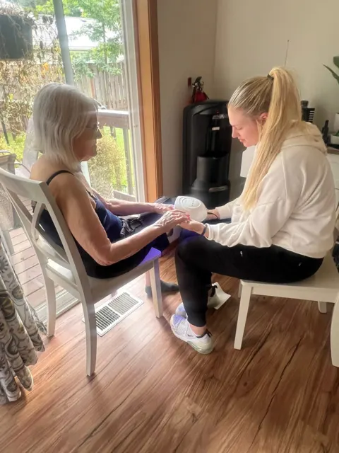 Resident and staff spending time together at AAA Shepherd’s Care Home