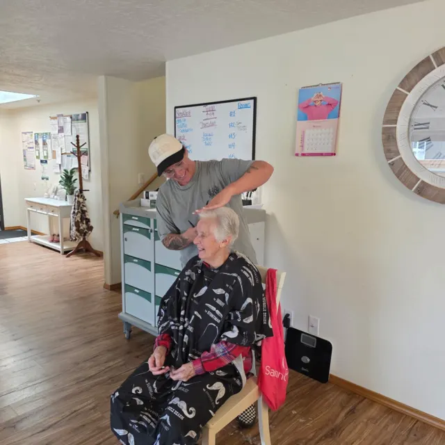 Resident and visitor sharing a playful moment at AAA Shepherd’s Care Home