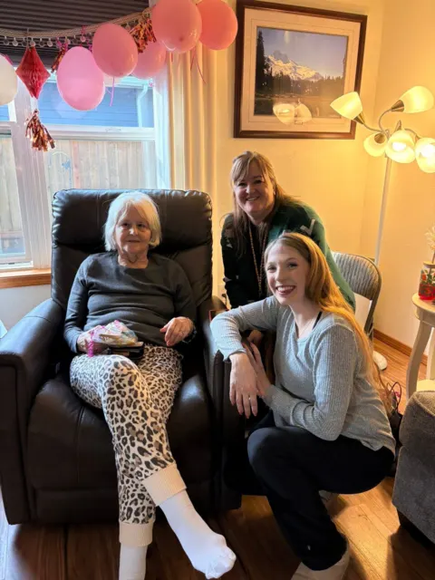 Resident and visitors celebrating with balloons at AAA Shepherd’s Care Home