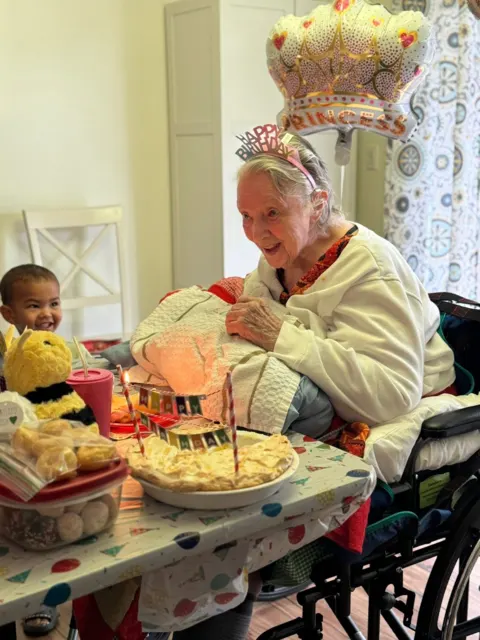 Resident celebrating a birthday with cake at AAA Shepherd’s Care Home