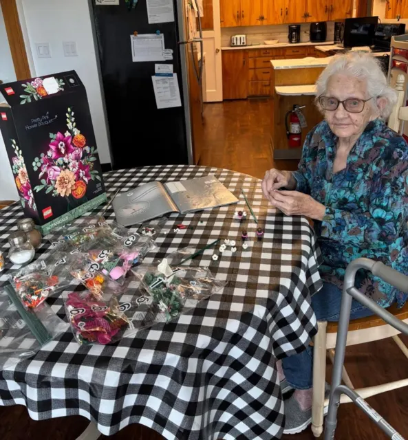 Resident enjoying an activity at the kitchen table at AAA Shepherd’s Care Home