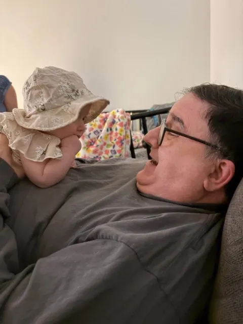 Resident meeting a baby at AAA Shepherd’s Care Home