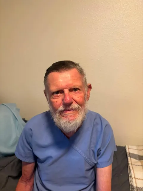 Resident smiling in a blue shirt at AAA Shepherd’s Care Home