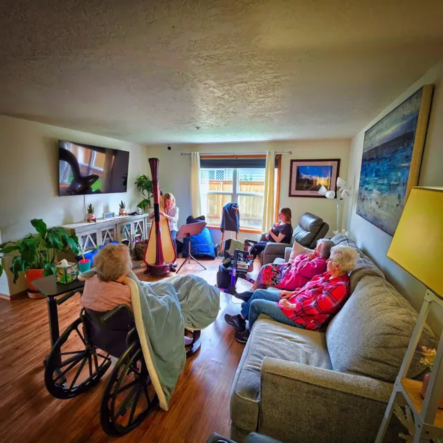 Residents listening to music in the living room at AAA Shepherd’s Care Home