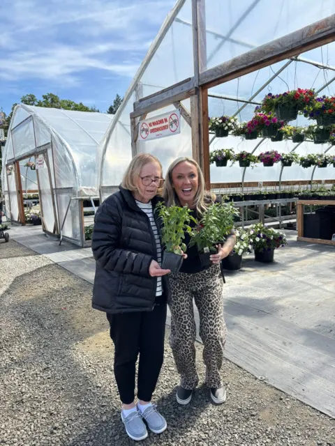 Smiling together during a garden nursery outing at AAA Shepherd’s Care Home