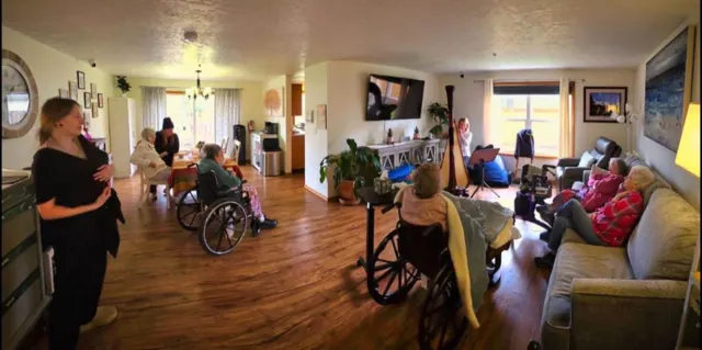 Staff and residents gathering for live music at AAA Shepherd’s Care Home