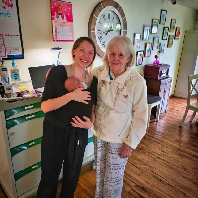 Staff member and resident smiling together at AAA Shepherd’s Care Home